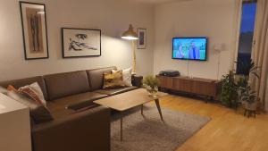 a living room with a couch and a tv at 3 bedrooms home with nice terrace in Stavanger