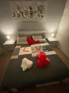 a bedroom with a large bed with clothes and towels at HOME ADRIANA in Bari