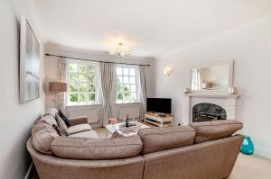 a living room with a couch and a fireplace at 8 Kents Bank House in Grange