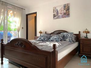 sypialnia z drewnianym łóżkiem z poduszkami w obiekcie Lux Apartment - Lakefront Apartment in Kamień with Sauna & Hot Tub Only 30 Minutes from Gdańsk and Gdynia w mieście Kamień