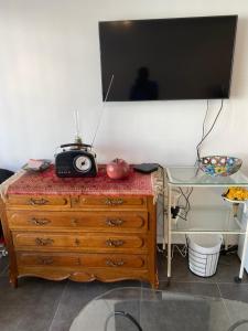 a dresser with a television on top of it at Gîte Chez Aude in Florenville