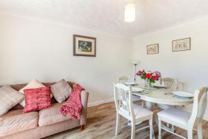 a living room with a couch and a table at Springfield Cottage in Chipping +20 photos