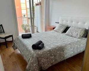 a bedroom with a bed with two pillows on it at Large Apartment near FIRA and City Center in Hospitalet de Llobregat
