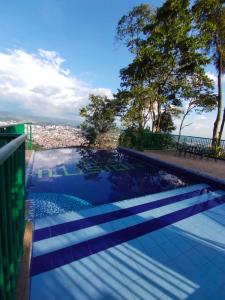 a swimming pool with a view of the city at Finca Hotel Villa Ilusión in Pereira