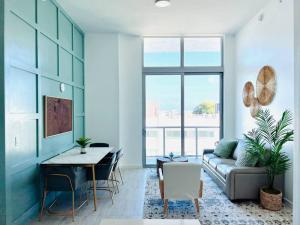 a living room with a couch and a table at Sleek 2BD 2BA Condo In Miami Design District in Miami