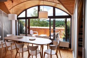 a dining room with a table and chairs at Apartmány Mind Adventure in Lštění