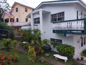 un edificio bianco con balcone e piante di 4Js Vacation Inc. - Luxury Studio a Gros Islet