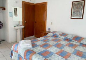 una camera con letto e lavandino di Hotel Puerto Villamar a Tepoztlán