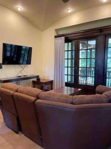 a living room with a couch and a table at 3 Bedroom Villa in Hacienda Pinilla in Tamarindo
