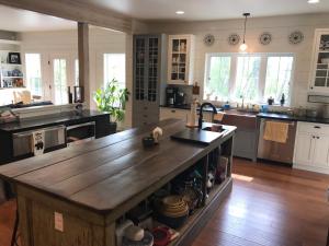 a kitchen with a large wooden island in the middle at Snowgoose Pond Bed & Breakfast in Palmer