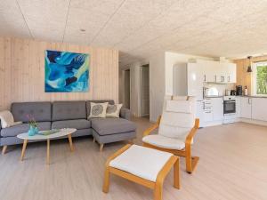 a living room with a couch and chairs and a table at 6 person holiday home in Læsø-By Traum in Læsø