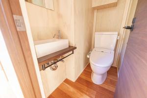 a small bathroom with a toilet and a sink at オーシャンリゾート ザ クリフ in Shimoda