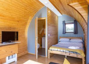 a bedroom with a bed and a tv in a room at South View Retreat in Carlton