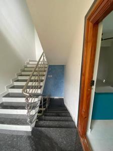 a staircase in a building with a metal railing at AR Springfields(1), amidst lush green scenic view in Manipala