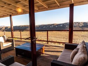 a screened in porch with a view of the desert at Rooilande Guest Farm Guest House in Laingsburg