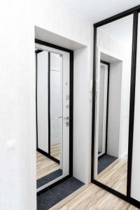 a row of mirrors in a white room at Люкс 1 комнатная in Rudny