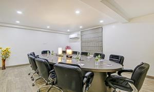 a conference room with a large table and chairs at Treebo Trend Ahinsa Residency Sohna Road in Gurgaon