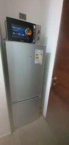 a refrigerator with a tv on top of it at Arriendo departamento in Santiago