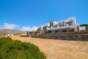 a large white house on top of a hill at Enea by TinosHost in Tinos