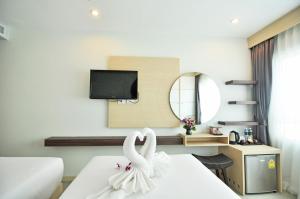 a hotel room with a swan sitting on a bed at The AIM Patong Hotel in Patong Beach