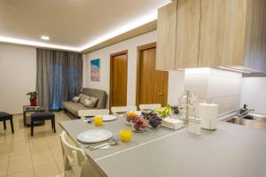 a kitchen and living room with a table with food on it at Rhodes City Center Suite in Rhodes Town