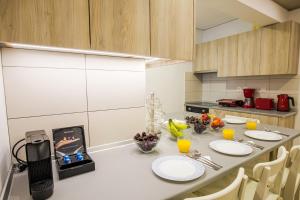 a kitchen with a table with plates of food on it at Rhodes City Center Suite in Rhodes Town +24 photos