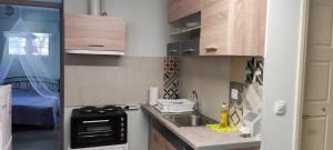 a small kitchen with a sink and a stove at Oasis in Nafplio