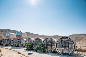 a group of circular glass spheres in the desert at Tsavta in Mashabbe Sade