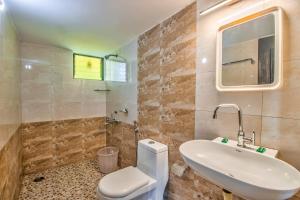 ein Badezimmer mit einem weißen WC und einem Waschbecken in der Unterkunft Villa Verediana in Candolim