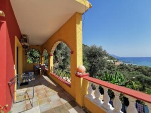 a balcony of a house with a view of the ocean at Pelekas Beach Apartments in Pelekas