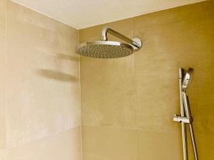 a shower with a shower head in a bathroom at Ferienwohnung Kerschbaumer in Gries am Brenner
