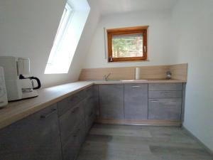a kitchen with a sink and a window at Ferienhaus Eugenie in Sulzfeld (im Grabfeld)