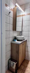 a bathroom with a sink and a mirror at Central Double Room Ground floor in Heraklio
