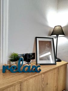 a wooden shelf with a picture and a lamp on it at Central Double Room Ground floor in Heraklio Town