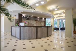 a lobby with a reception desk in a building at Hotel Coop - Kiten in Kiten +143 photos