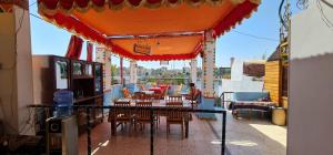 a patio area with tables, chairs and umbrellas at Nuba Dool Guest House in Aswan
