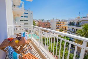 a balcony with a table and chairs on a building at Rhodes City Center Suite in Rhodes Town