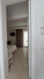 a bedroom with a bed and a television in a room at MandorleOlio in Polignano a Mare