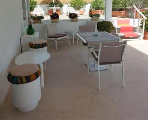 a patio with tables and chairs and a table at MandorleOlio in Polignano a Mare