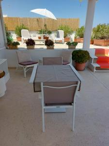 a table and chairs and an umbrella on a patio at MandorleOlio in Polignano a Mare