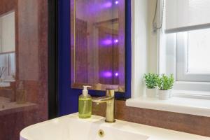a bathroom sink with a bottle of soap on it at Cormorant PLACE LUXURY PAD in Portsmouth