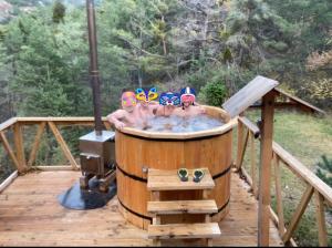 a group of people in a hot tub on a deck at chalets cocody in Jausiers