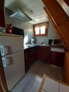 an overhead view of a kitchen with a white refrigerator at chalets cocody in Jausiers