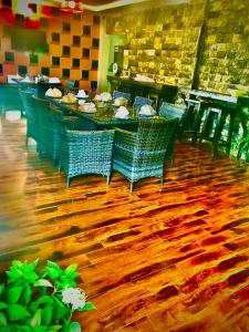 a restaurant with a table and chairs on a wooden floor at Boutiqueinn Ayubia in Ayubia