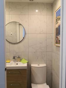 a bathroom with a toilet and a sink and a mirror at Joli studio dans le coeur de Menton in Menton
