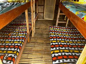 two stairwells in a room with two bunk beds at Onyong's Floating Cottage in Calatagan