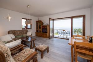 a living room with a couch and a table at Bela Vista 4 Rustikales Appartement in Volosko