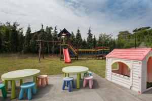 a play area with tables and a play house at Bungalow Kapitański in Jastrzębia Góra