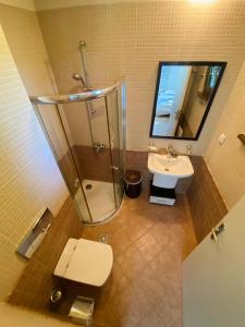 a bathroom with a shower and a toilet and a sink at La Terraza del Oasis in Lozenets +5 photos