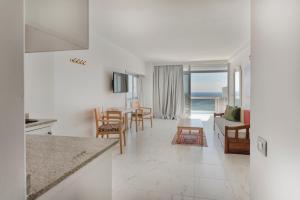 a kitchen and living room with a view of the ocean at Hotel Europalace in Playa del Ingles